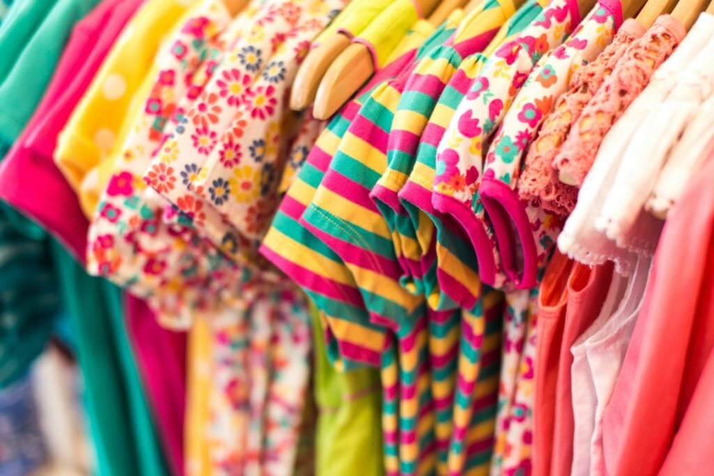 A selection of baby clothes in soft colours
