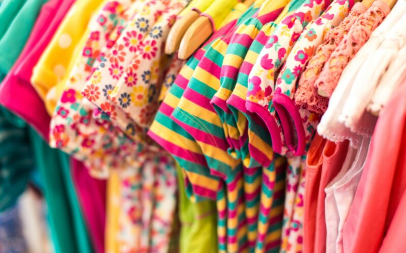 A selection of baby clothes in soft colours